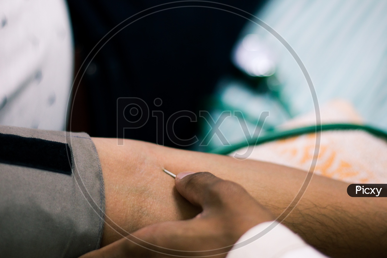 Needle For Blood Collection Inserted In Arm Of Patient By Attendant