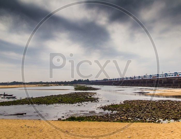 Landscape Scene Of River Bed Sandy Beach With Cloudy Sky
