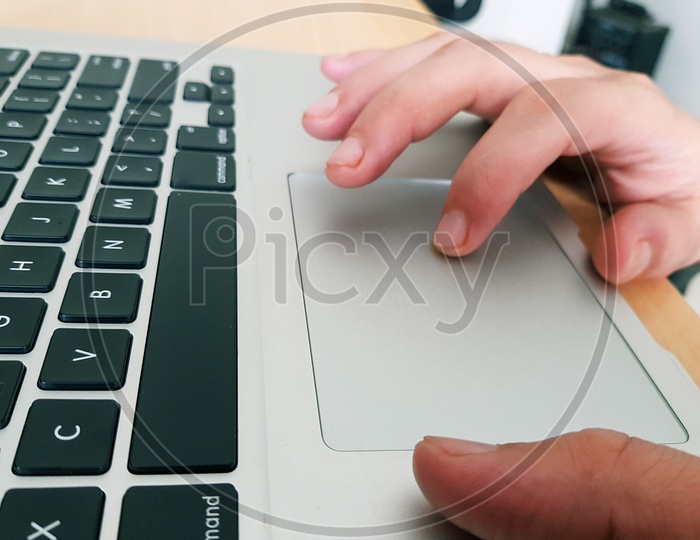 Fingers Operating Touchpad Of A Laptop