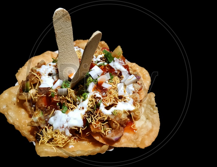 papdi chaat indian spicy snack isolated in black background