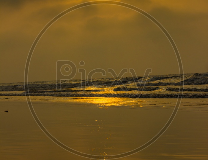 Golden Sunrise Sunset Twilight Hour. Sun Rays Reflecting On Sea Water And Shore.Vertical Orientation