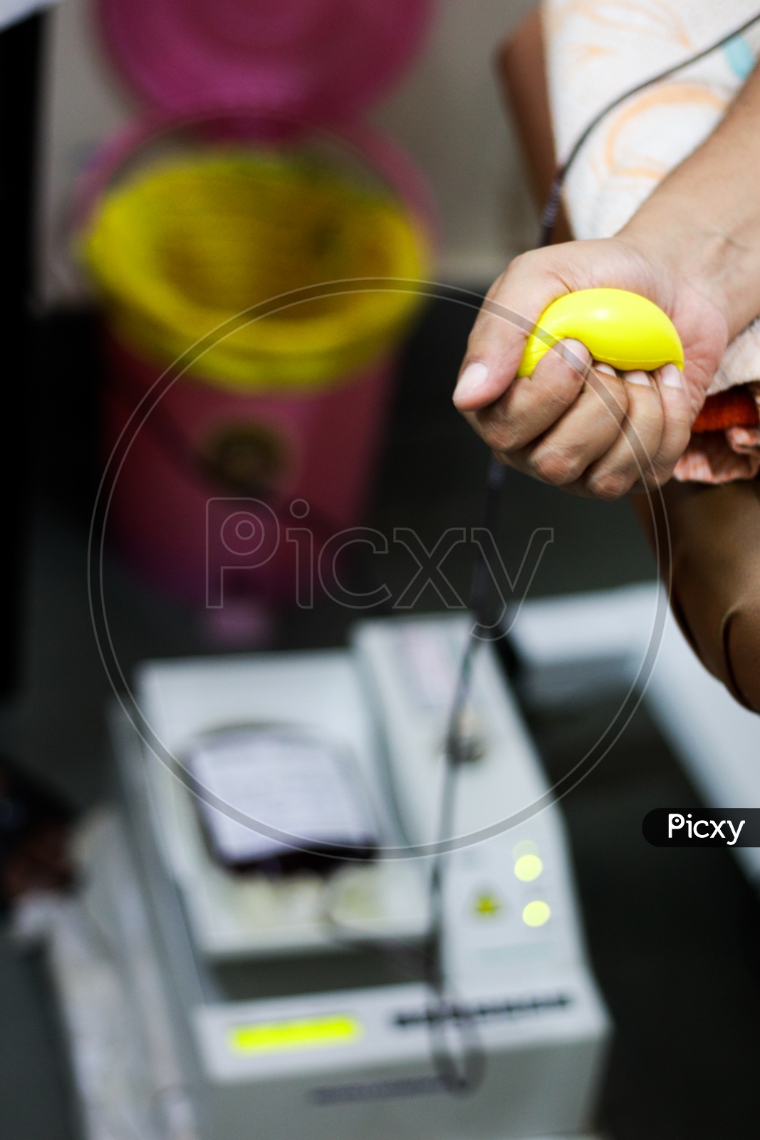 Selective Focus Of Blood Collection During Blood Donation And Ball In Palm For Squeezing