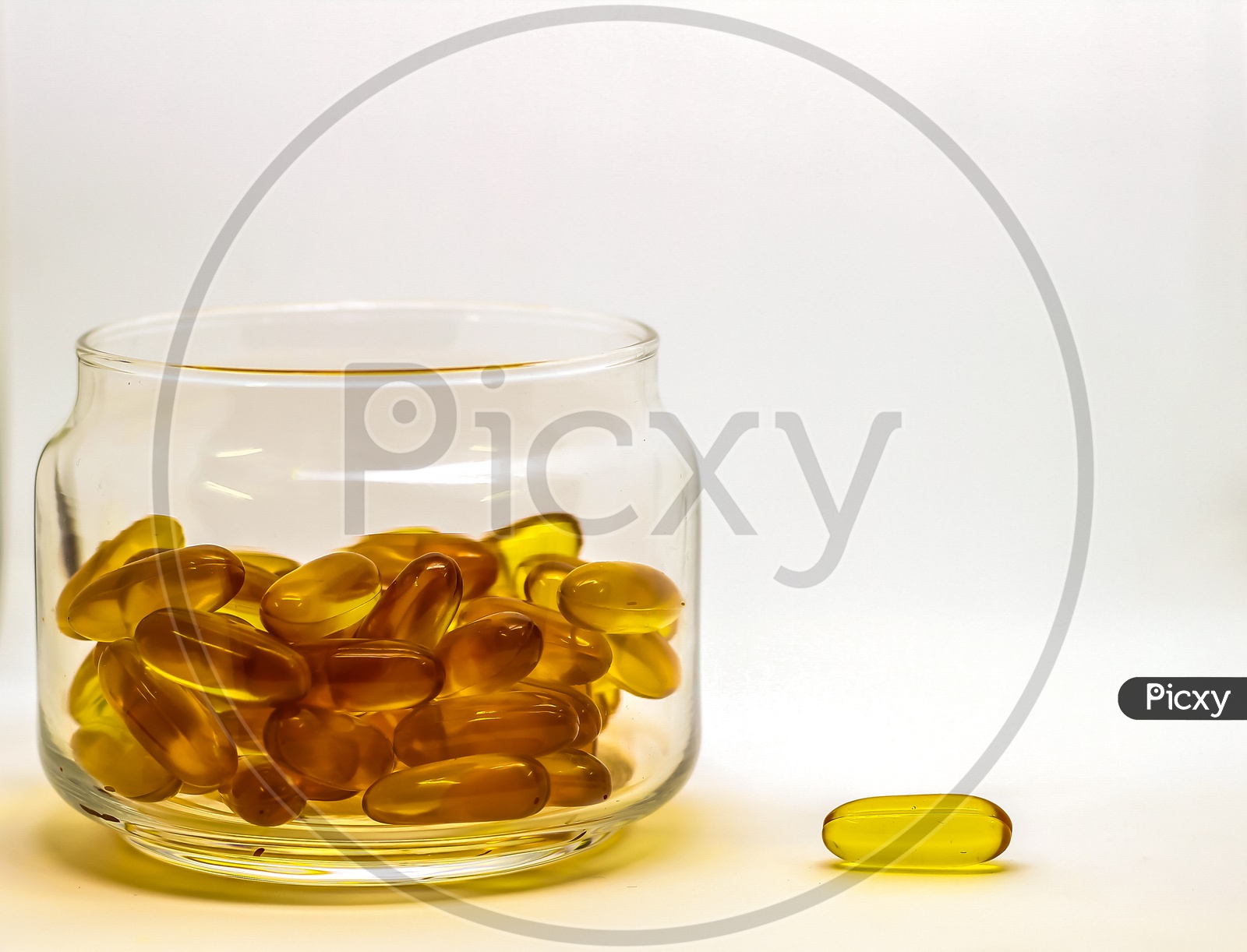 Cod Liver Oil Omega 3 Vitamin E Gel Capsules Isolated On White Background In A Transparent Glass Bottle