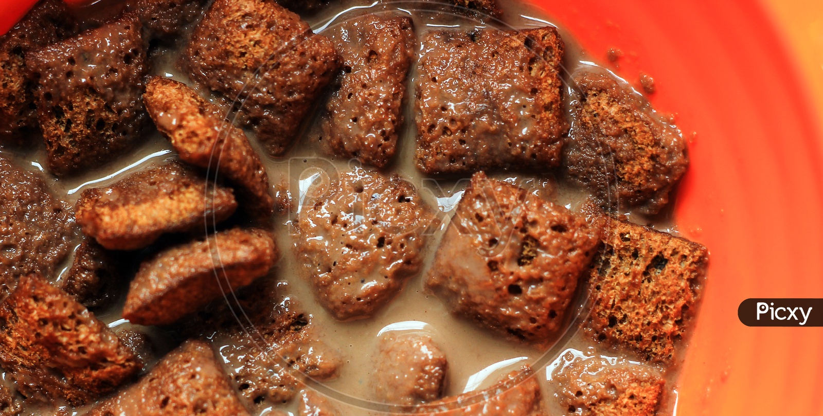 Close Up Photo Of Chocolate Cornflakes Dipped In Chocolate Milk