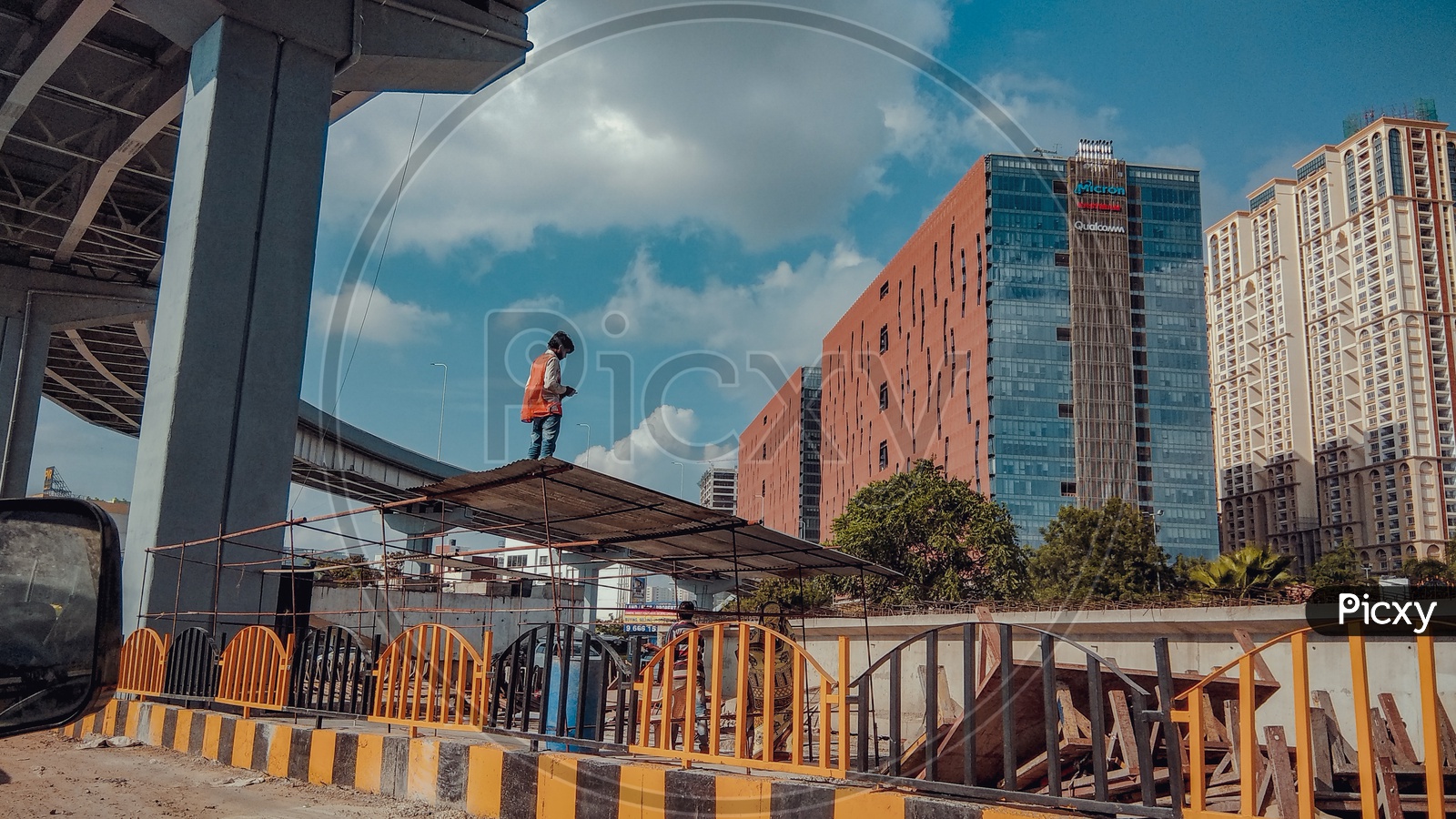 A Construction Worker With The Skyview Building In Background