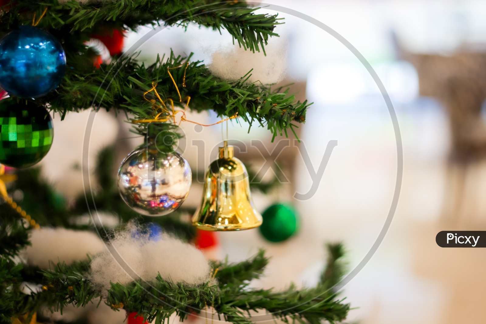 Christmas Decoration With Gift Bells Balls Boxes Boots Stars With Christmas Tree And Cotton With Blurred Background