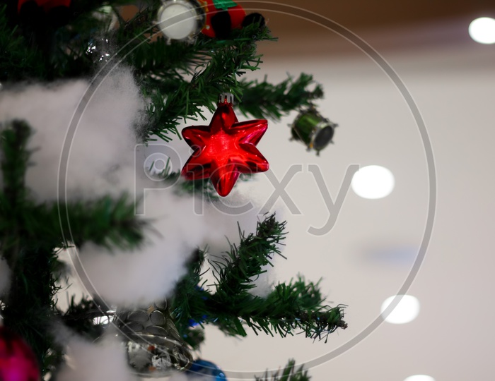 Christmas Decoration With Drums Toffee Gift Bells Balls Boxes Boots Stars With Christmas Tree And Cotton With Blurred Background