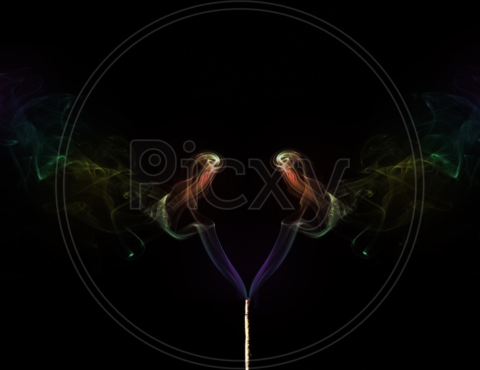 Coloured Smoke Coming Out Of Incense Sticks. Abstract Smoke Art