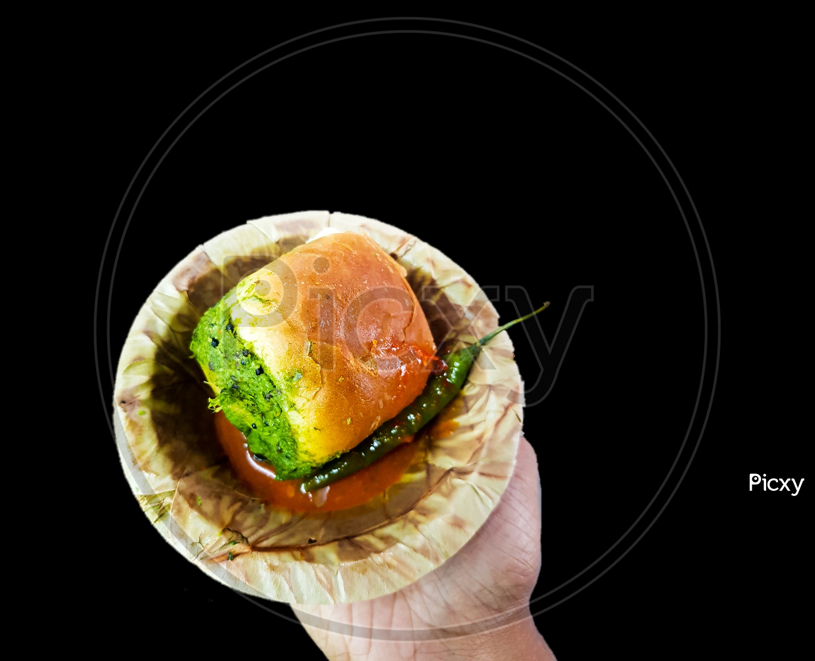 Vada Pau Bread And Green Sauce On A Plate In Dark Background On Hand