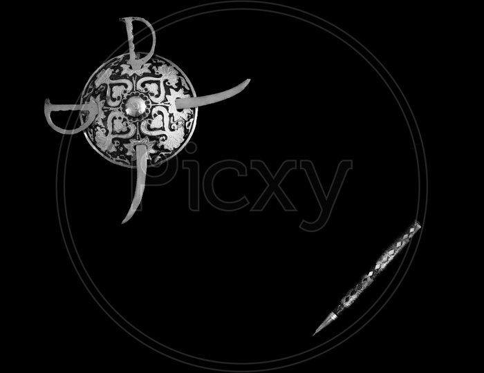 Decorated Round Sword And Shield And Pen Isolated In Black Background With Copy Space For Text. Black And White.Antique Artefact