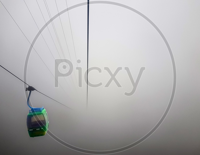 A Cable Car Suspended In A Cable In A Very Foggy Weather With Zero Visibility