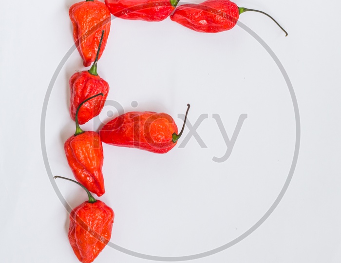 Letter F Alphabet Made With Ghost Pepper Bhoot Jolokia Over White Background