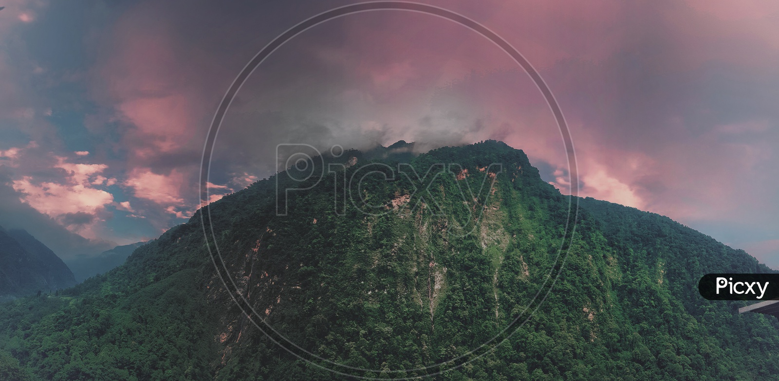Red Sky With Fog On A Mountain Top With Green Vegetation