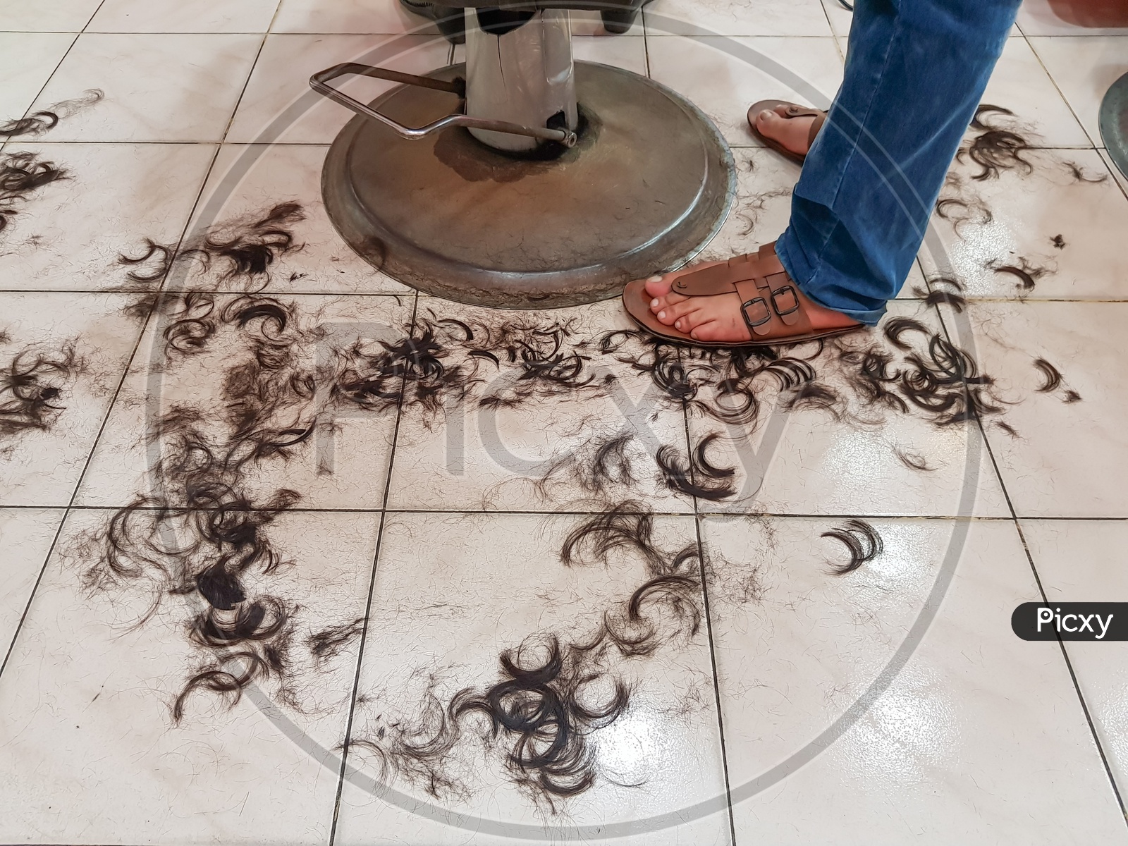 Dirty Floor Of A Hair Salon With Hairs On Floor In Barber Shop