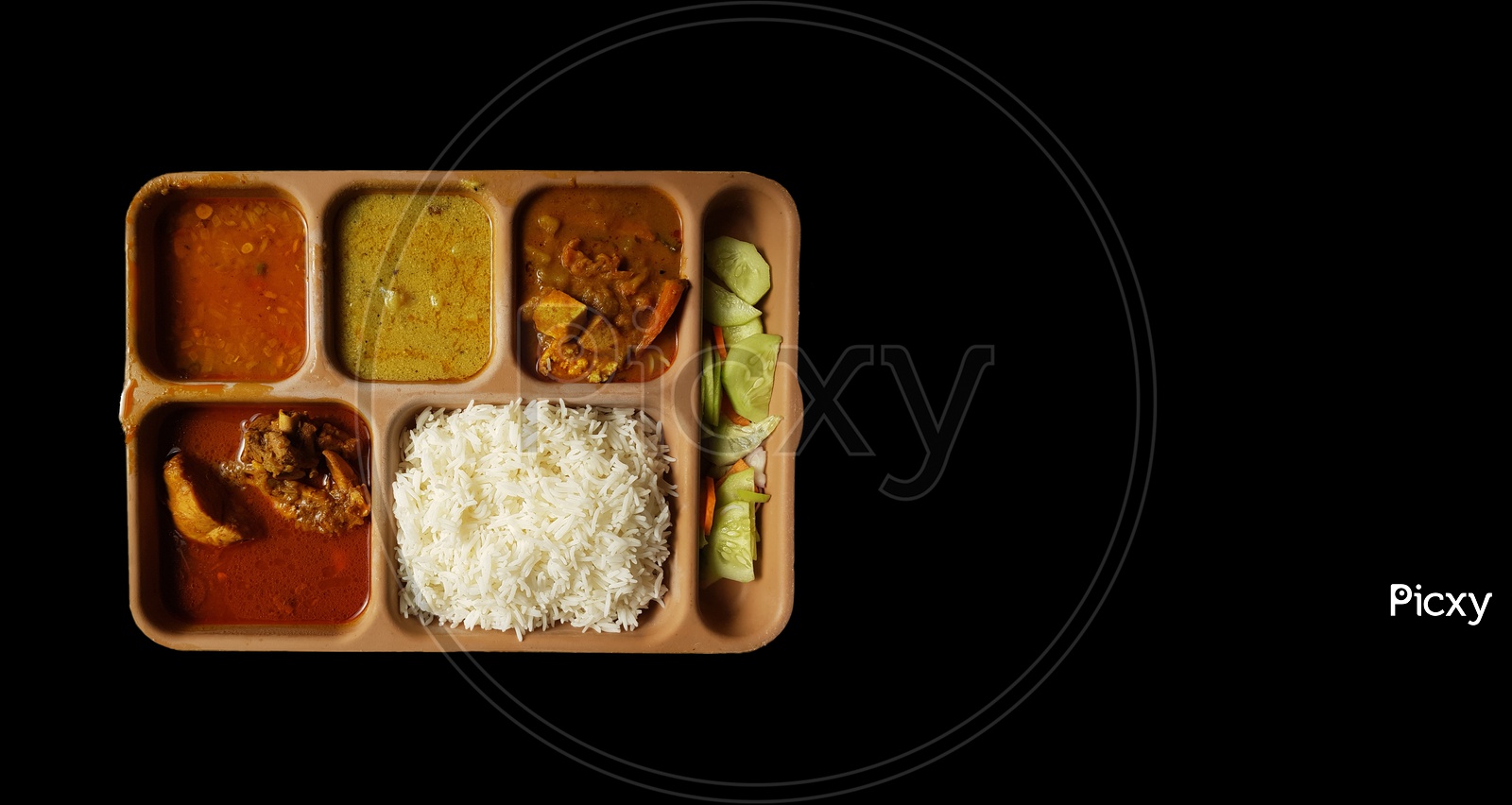 Indian Chicken Thali With Rice Dal Chicken Salad Vegetable Curry On A Plastic Segmented Plate In Black Background