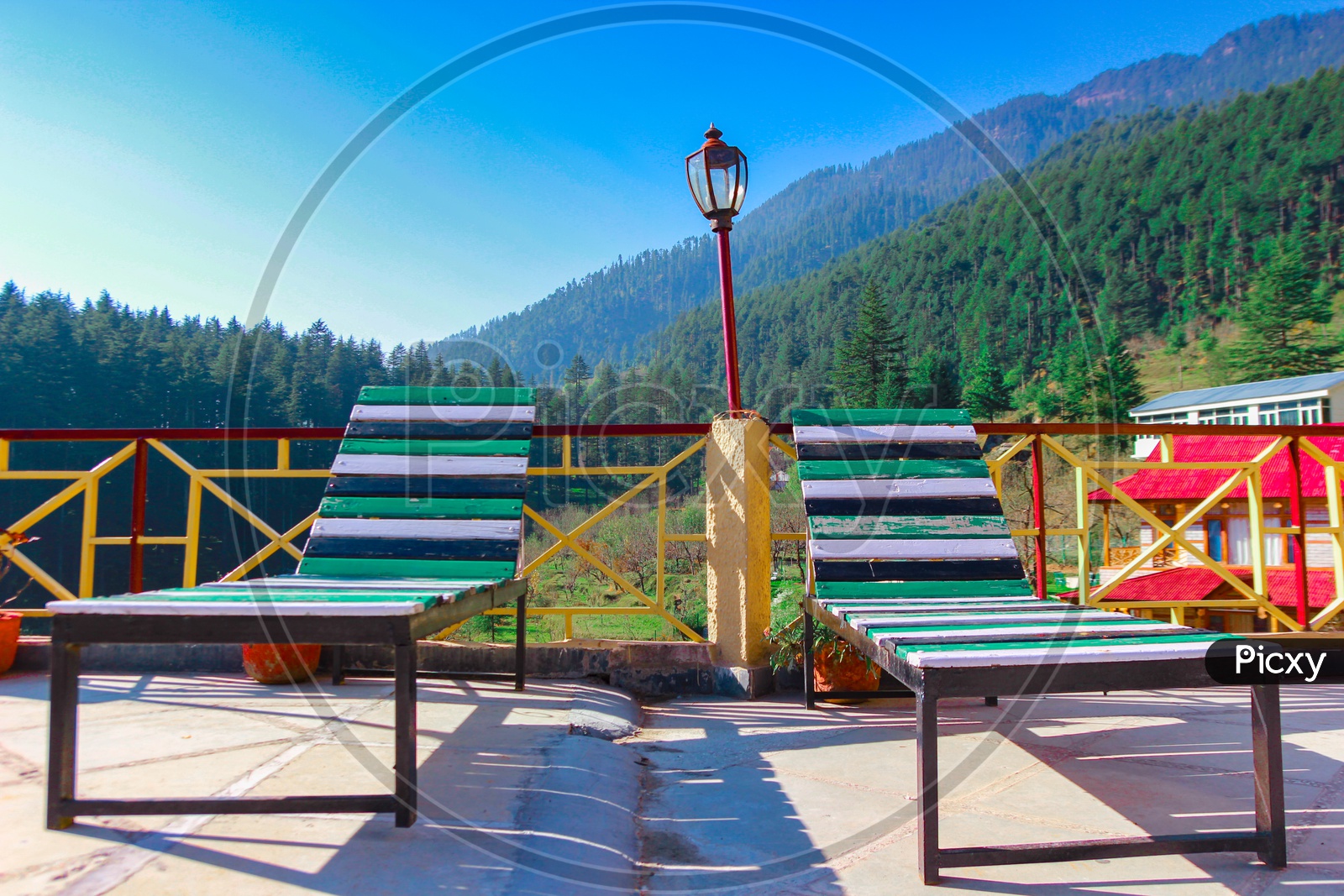 Resting Wooden Easy Chair With Himalayan Hills In Background With Blue Skies During Runrise
