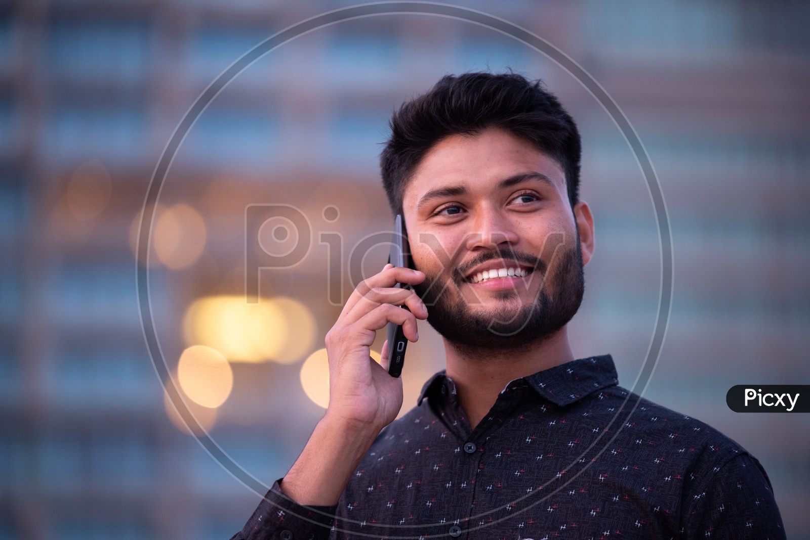 Indian Male Student Speaking  in Smartphone With a Smile Face