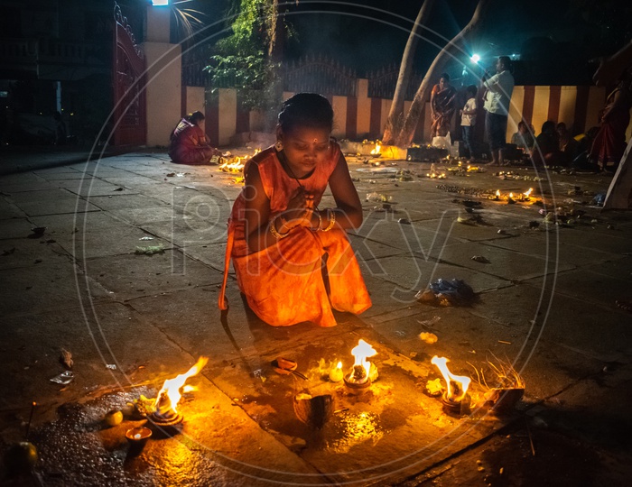 Girl praying to God on Diwali
