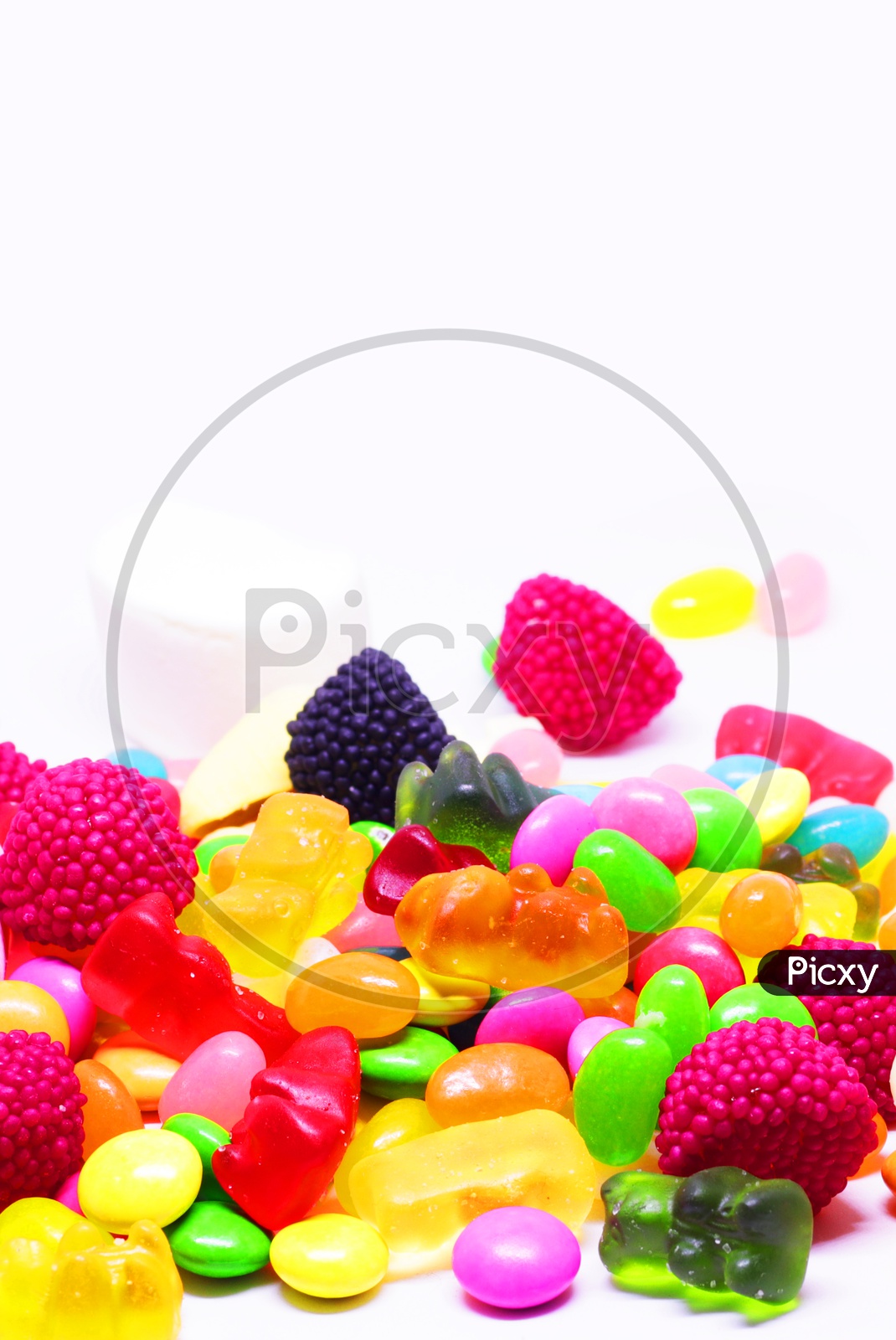 Multiple Coloured Sugar Candy In White Background In Vertical Orientation