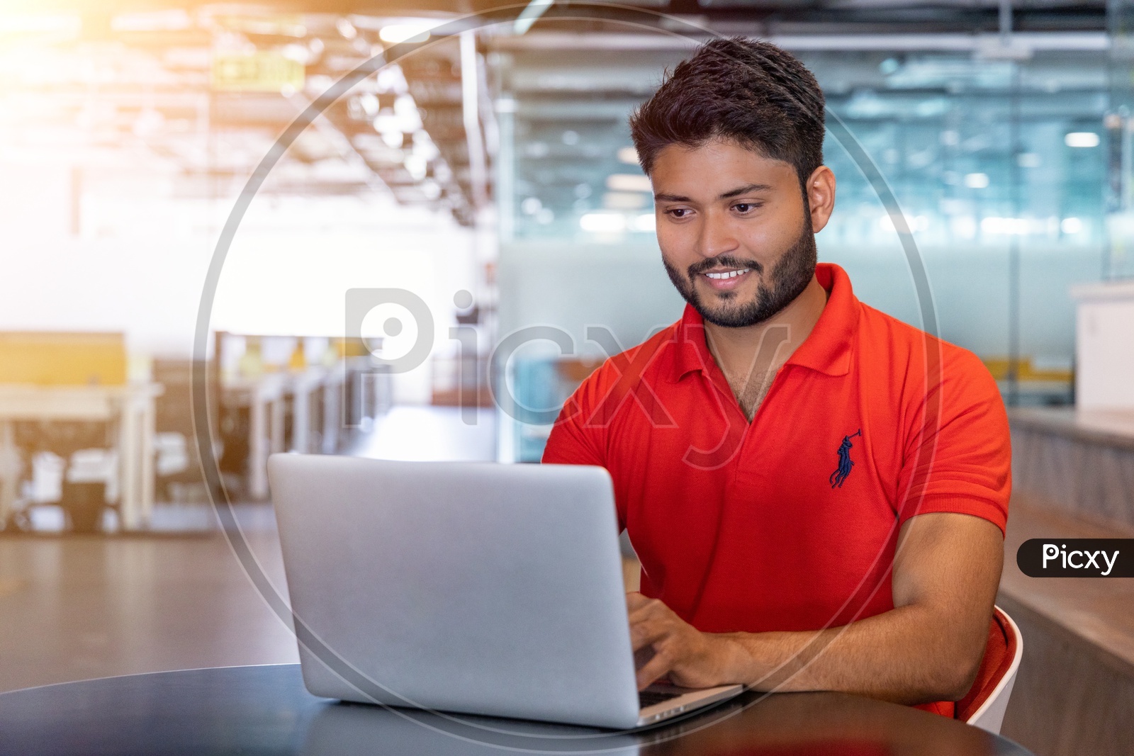 Indian Male student working on laptop