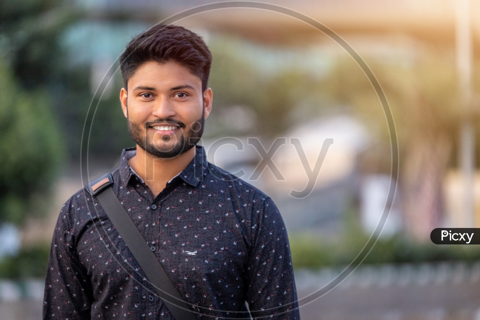 Happy Indian Male Student Smiling  in Outdoor Background