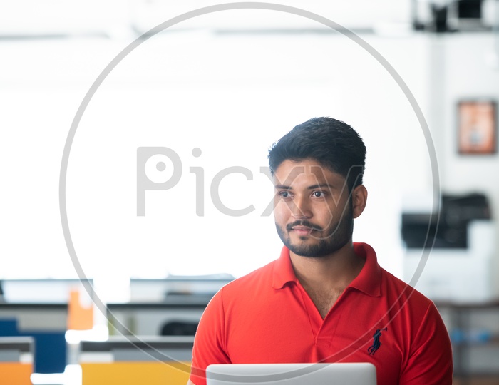 Young Indian Male Student with Laptop