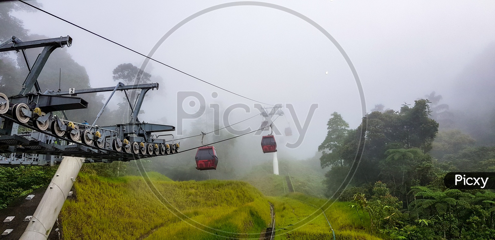 Cable Car At Genting Highlands, Malaysia In A Foggy Weather With Green Grass Visible From Inside Cable Car
