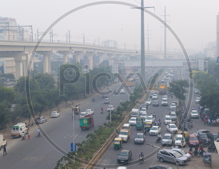 Pollution at Severe Level In Delhi NCR, Vehicles on road and Delhi metro line over bridge