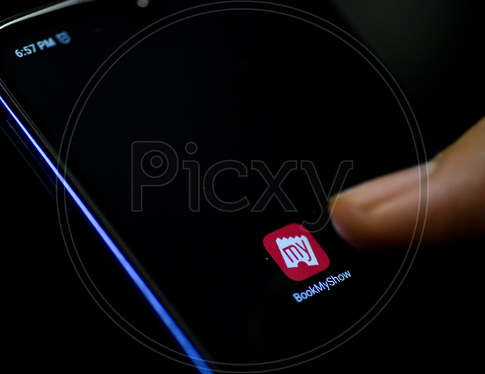 Bookmyshow  Mobile App Icon Opening on Smartphone Screen  Closeup With Finger