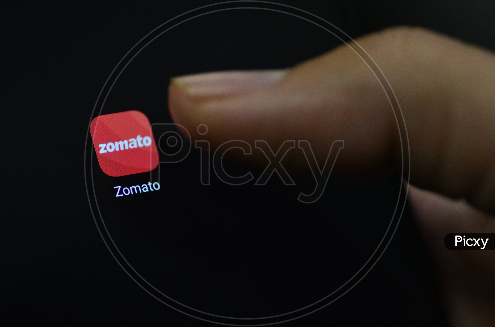 Zomato  Online Food Delivery  Mobile App Icon Opening on Smartphone Screen  Closeup With Finger