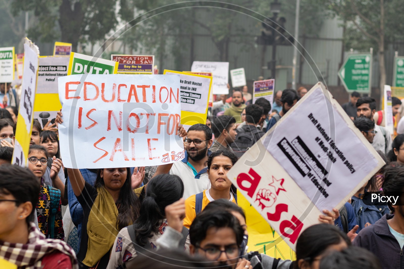 A girl with 'Education is not for sale' banner and Students and teachers from different universities and different organisations demanding withdrawal of draft 'National Education Policy 2019' and protesting against other issues related to Education