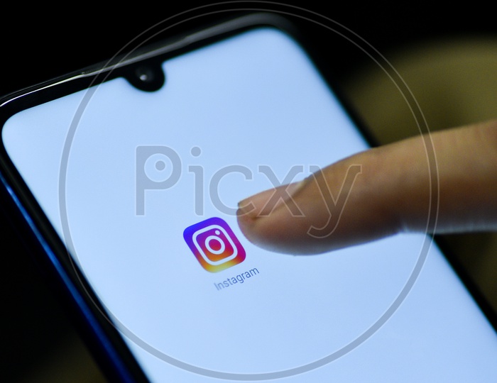 Instagram Mobile App Icon Opening on Smartphone Screen  Closeup With Finger