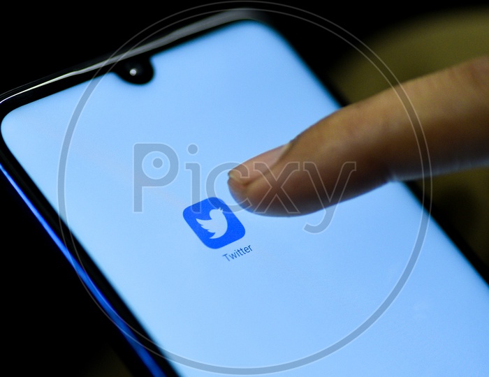Twitter  Mobile App Icon Opening on Smartphone Screen  Closeup With Finger