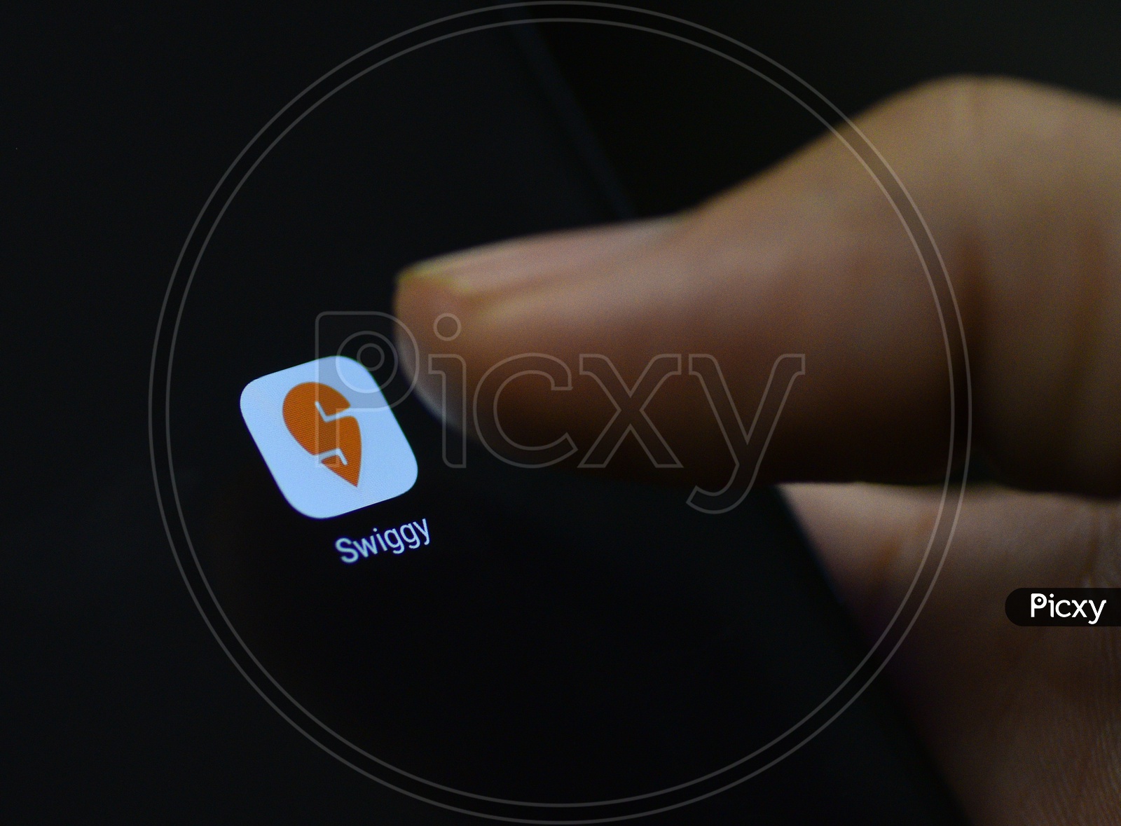 Swiggy Online Food Delivery  Mobile App Icon Opening on Smartphone Screen  Closeup With Finger