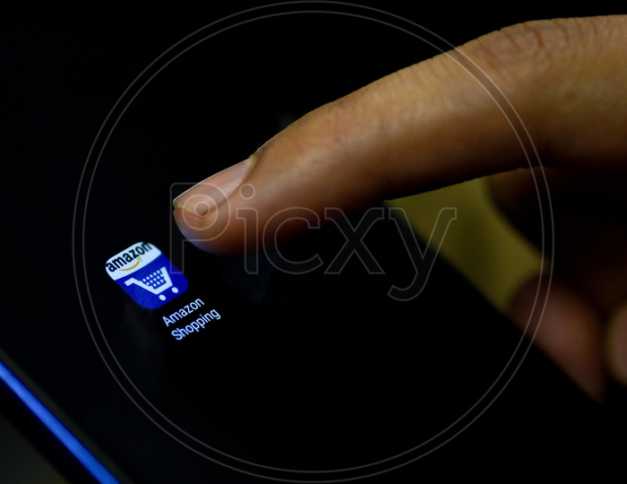 Amazon Shopping Mobile App Icon Opening on Smartphone Screen  Closeup With Finger
