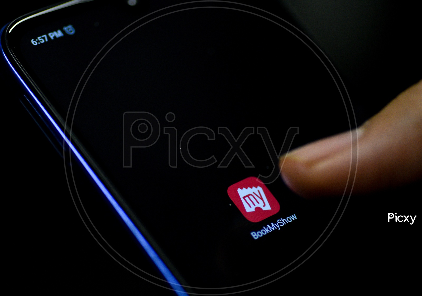 Bookmyshow  Mobile App Icon Opening on Smartphone Screen  Closeup With Finger