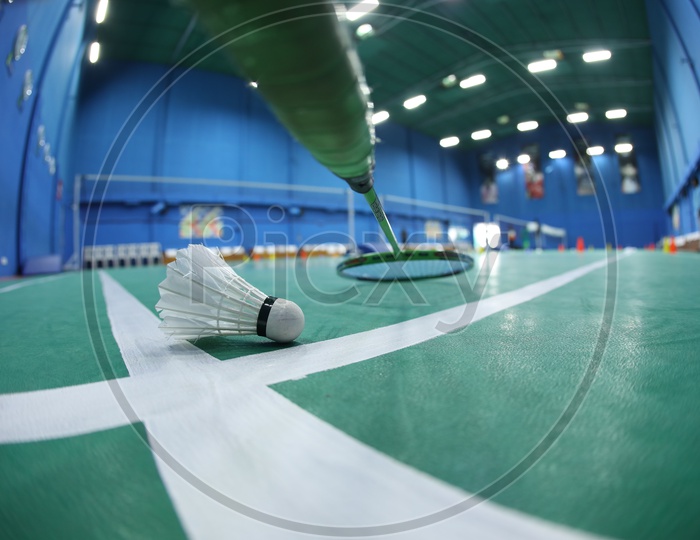 Shuttle And Badminton Bat in A Shuttle Badminton Indoor Synthetic Court
