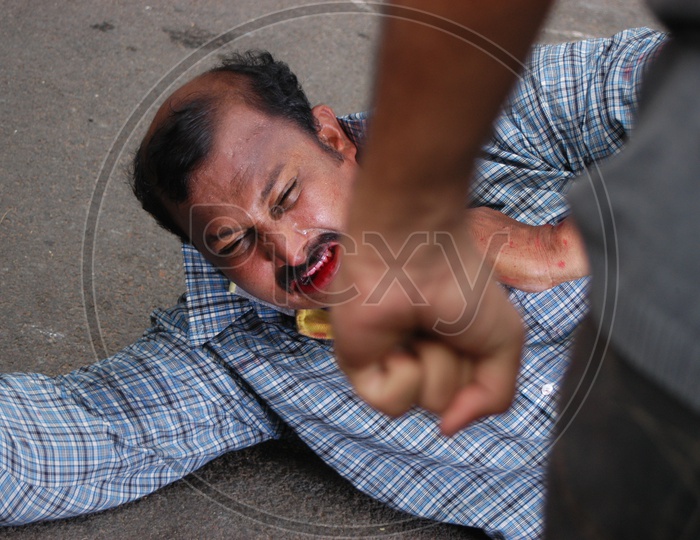 Indian man being Beaten by Another Bleeding From Mouth  In an Movie Working Still