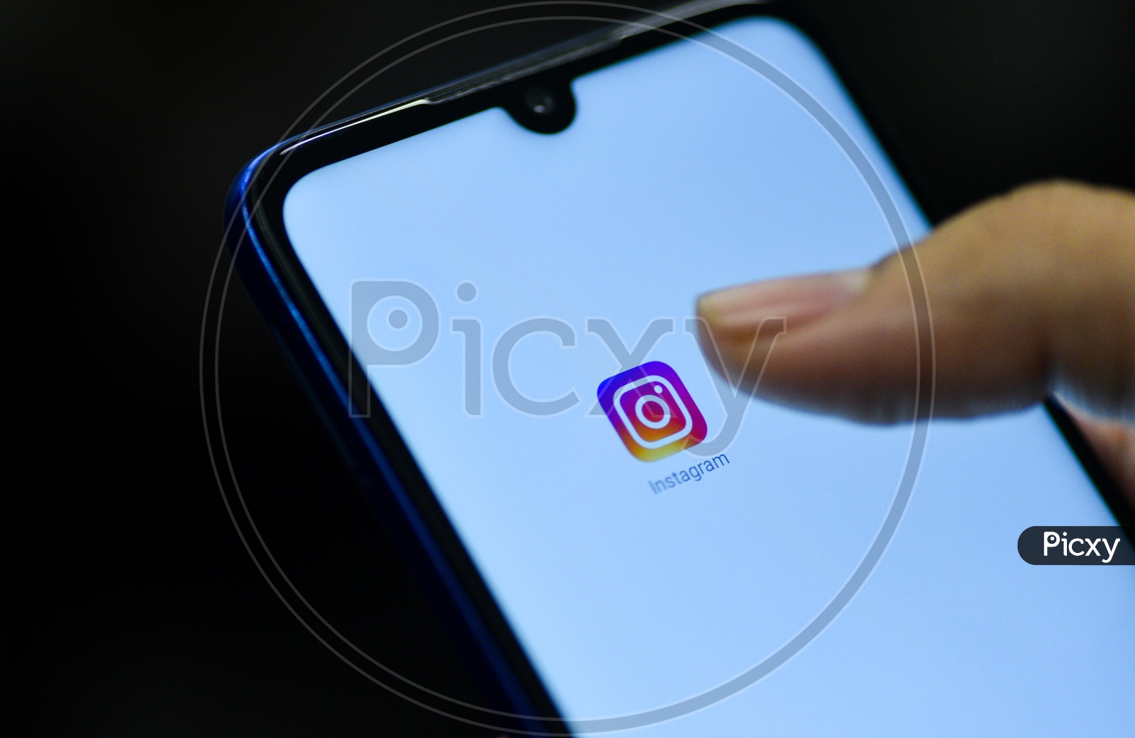 Instagram  Mobile App Icon Opening on Smartphone Screen  Closeup With Finger