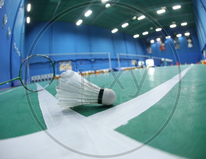 Shuttle And Badminton Bat in A Shuttle Badminton Indoor Synthetic Court
