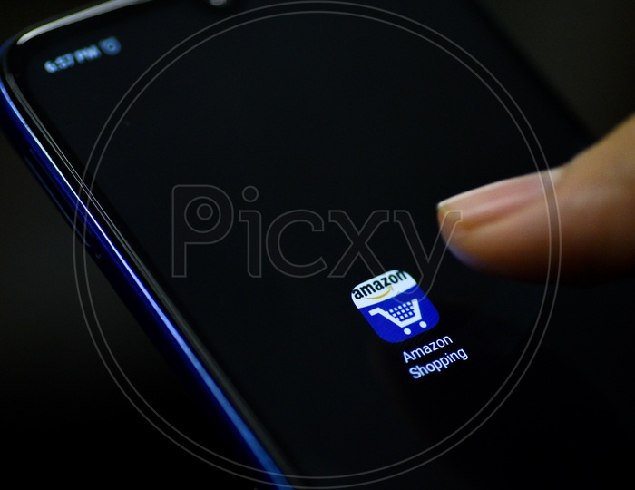 Amazon Online shopping  Mobile App Icon Opening on Smartphone Screen  Closeup With Finger