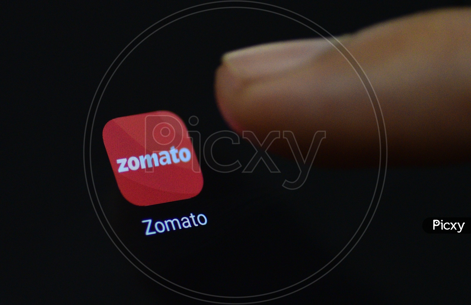 Zomato  Online Food Delivery  Mobile App Icon Opening on Smartphone Screen  Closeup With Finger