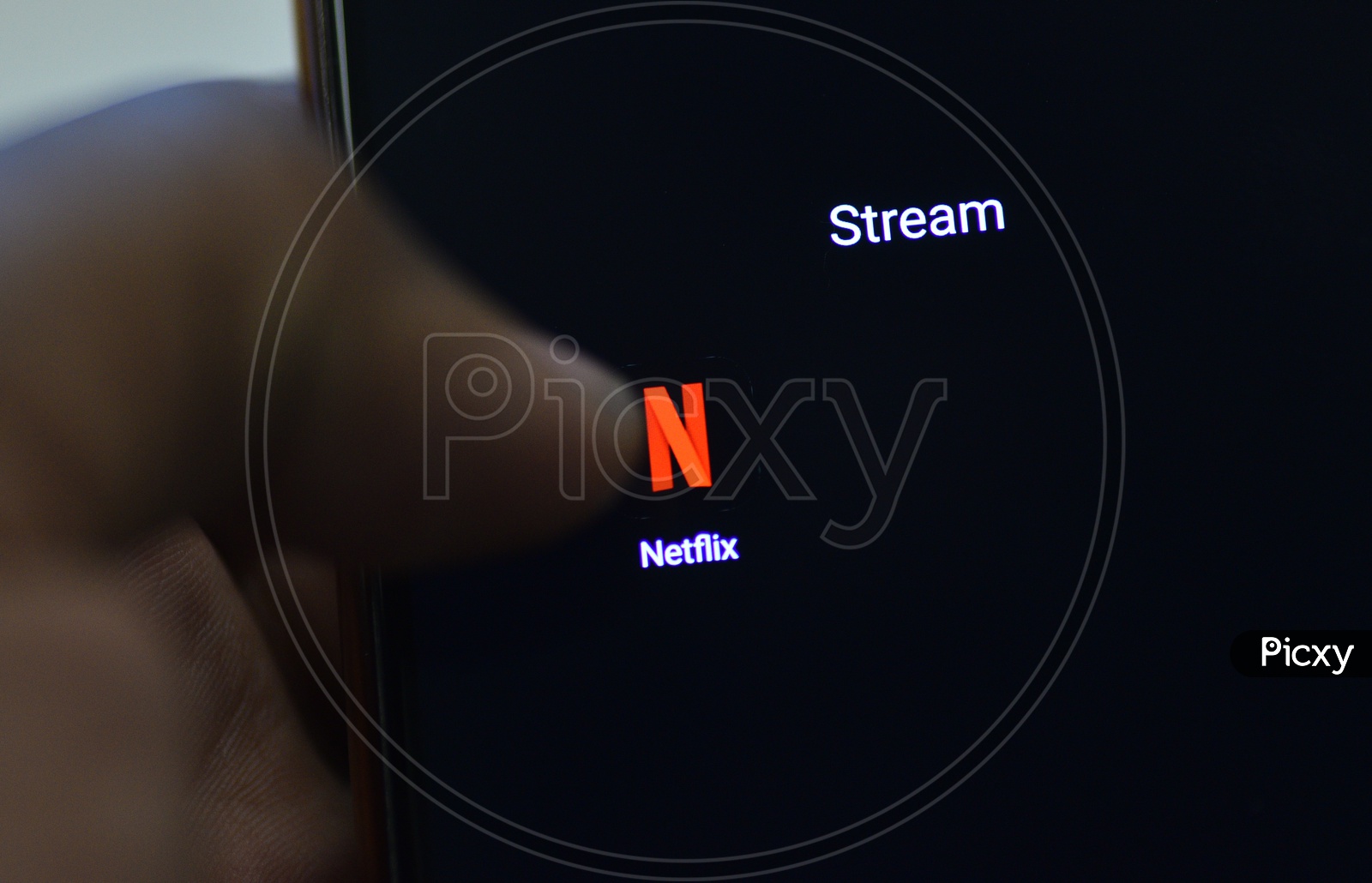 Netflix Mobile App Icon Opening on Smartphone Screen  Closeup With Finger