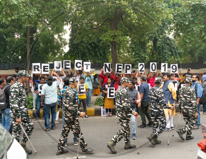 Students and teachers from different universities demanding withdrawal of 'National Education Policy 2019' and security forces around them