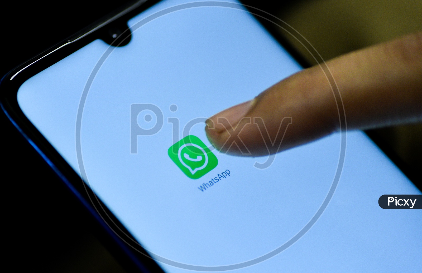 Whatsapp   Mobile App Icon Opening on Smartphone Screen  Closeup With Finger