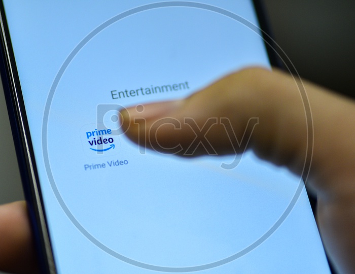 Amazon Prime  Mobile App Icon Opening on Smartphone Screen  Closeup With Finger