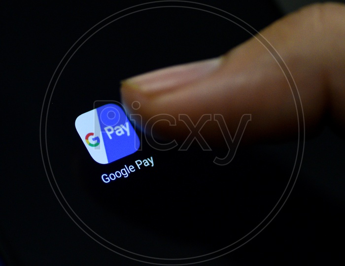 Gpay Online Payments Mobile App Icon Opening on Smartphone Screen  Closeup With Finger