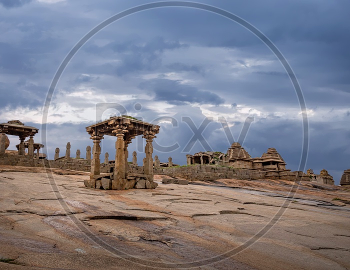 Ruins on Hemakuta Hill in Unesco World Heritage Town Hampi on a cloudy day
