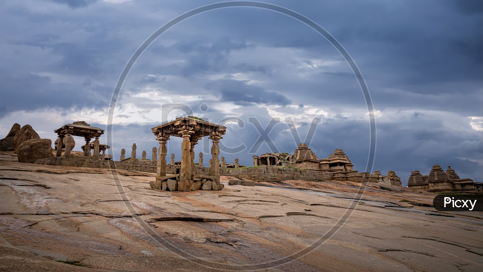 Ruins on Hemakuta Hill in Unesco World Heritage Town Hampi on a cloudy day
