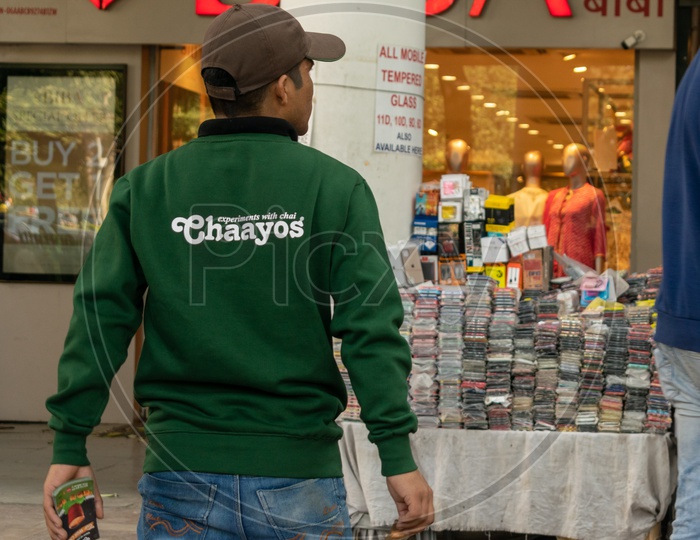 Man Wearing Chaayos T-shirt At An Tea Outlet Promoting The Brand